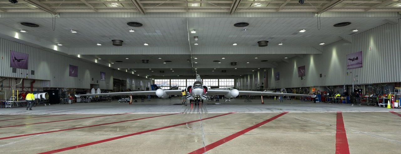 A high-altitude research aircraft inside a hangar.